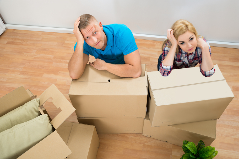 Portrait,Of,Worried,Young,Couple,With,Cardboard,Boxes